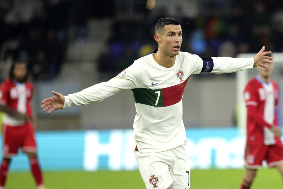 Portugal's Cristiano Ronaldo, center, in action during the Euro 2024 group J qualifying soccer match between Luxembourg and Portugal at the Stade de Luxembourg in Luxembourg, Sunday, March 26, 2023. (AP Photo/Olivier Matthys)