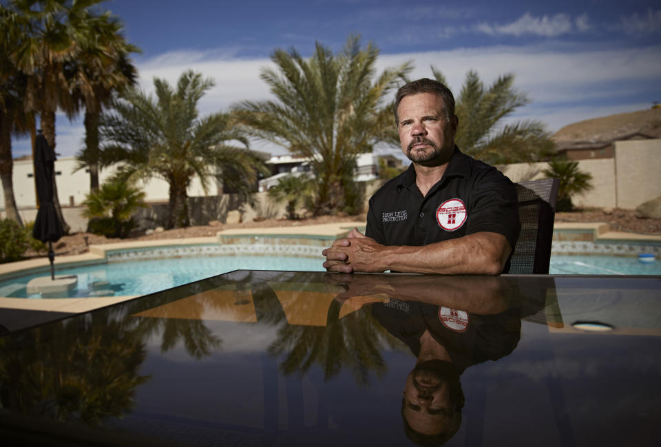 In this April 9, 2019, photo, Grant Whitus poses for a portrait at his home in Lake Havasu City, Ariz. Whitus' marriage fell apart a year after he led his SWAT team into Columbine High School's library, where he was the first to find the dead children's bodies. (AP Photo/John Locher)