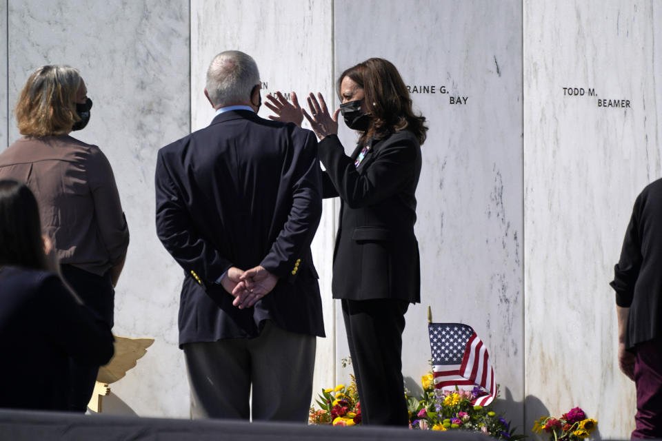 Vice President Kamala Harris, center, gestures as she visits with Ed Root, second from left, who is the cousin of Flight 93 passenger Lorraine G. Bay, and his daughter Emily, as they stand in front of Lorraine G Bay's stone on the Wall of Names at the Flight 93 National Memorial on Sept. 11, 2021 in Shanksville, Pa. (AP Photo/Gene J. Puskar)