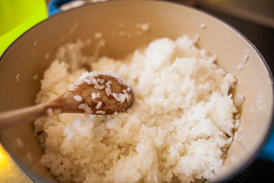 A bowl of rice with a spoon.