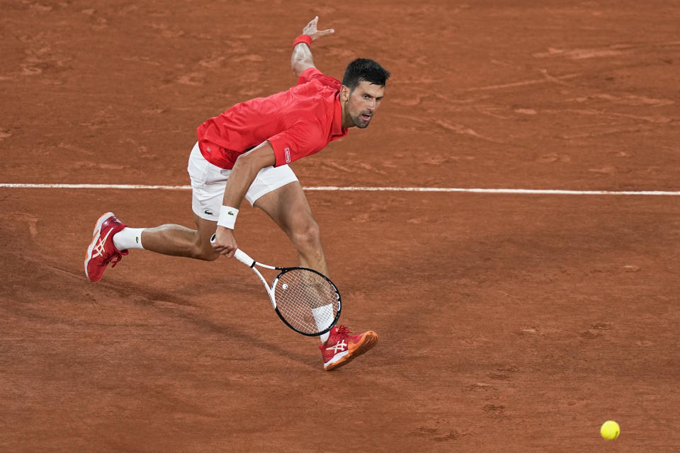 Serbia's Novak Djokovic plays a shot against Japan's Yoshihito Nishioka during their first round match at the French Open tennis tournament in Roland Garros stadium in Paris, France, Monday, May 23, 2022. (AP Photo/Michel Euler)