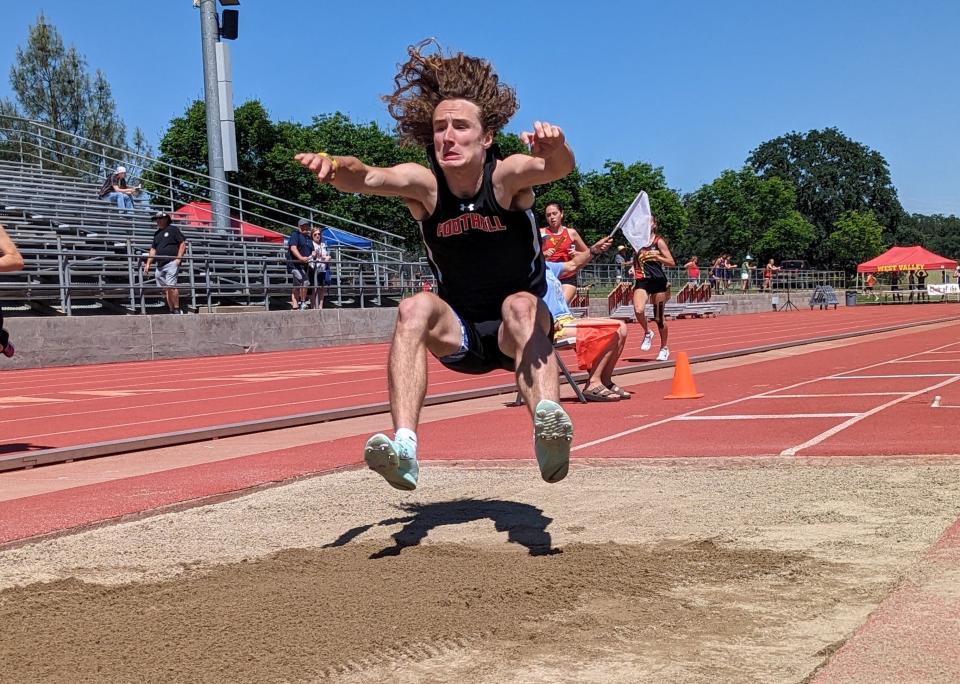 Foothill senior Chris Hall braces for impact while performing the long jump at the CIF Northern Section Track and Field Championships at West Valley High School on Friday, May 19, 2023.