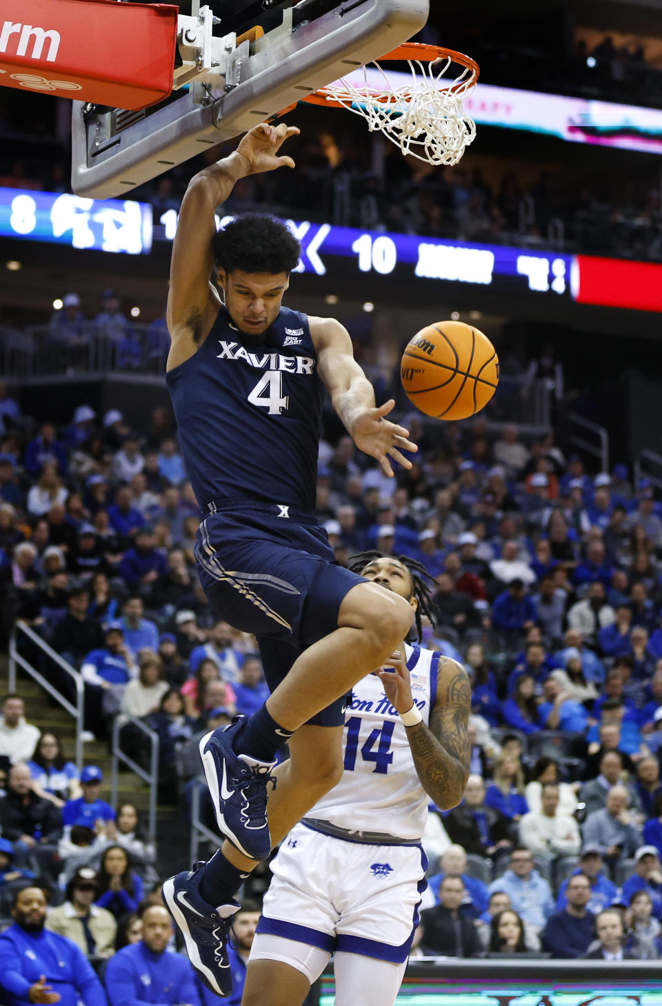 Xavier forward Cesare Edwards (4) dunks against Seton Hall guard Dre Davis (14) during the first half of an NCAA college basketball game in Newark, N.J., Friday, Feb. 24, 2023. (AP Photo/Noah K. Murray)