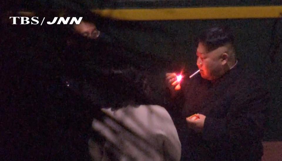 In this image made from Japan’s TBS TV video on early Tuesday, Feb. 26, 2019, North Korean leader Kim Jong Un, a habitual smoker, takes a pre-dawn smoke break at the train station in Nanning, China, hours before his arrival in Vietnam for his high-stakes summit with President Donald Trump over resolving the international standoff over the North’s nuclear weapons and missiles. (TBS-JNN via AP)