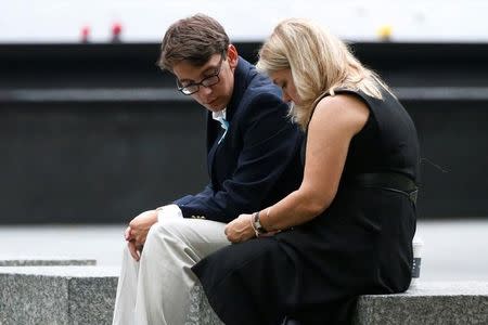 Guests sit near the memorial before the start of the ceremony marking the 15th anniversary of the attacks on the World Trade Center, at The National September 11 Memorial and Museum in Lower Manhattan in New York City, U.S. September 11, 2016. REUTERS/Brendan McDermid