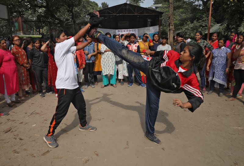 Girls practice a self-defense technique at a training camp in Kolkata