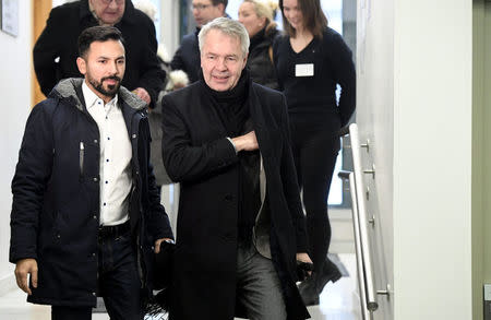 Green Party's presidential candidate Pekka Haavisto (C) and his spouse Antonio Flores arrive to give their vote during presidential election in Helsinki, Finland January 28, 2018. Lehtikuva/Heikki Saukkomaa/via REUTERS