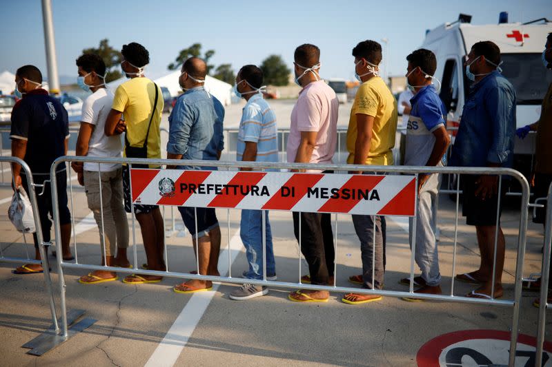 FILE PHOTO: Migrants on board Open Arms rescue boat arrive at Messina port