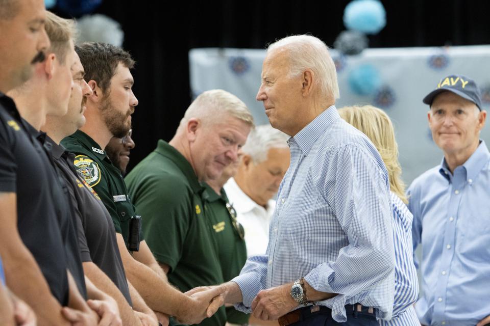 President Joe Biden shakes hands with service members who responded to Hurricane Idalia.