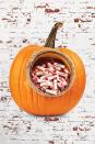 <p>This homemade beauty beats out any store-bought candy bowl. Just trace the bottom of a glass bowl or storage container to ensure that it'll fit inside. That way, you can safely store candy without covering it in the pumpkin's natural goop. </p>
