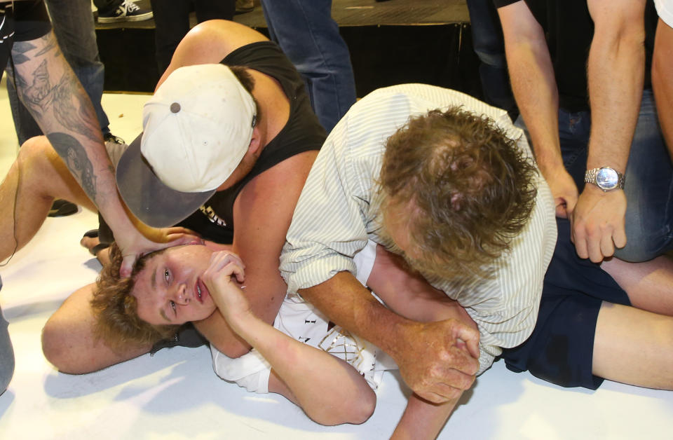 The teenager was pinned to the ground by the politician’s supporters (Picture: Yahoo)