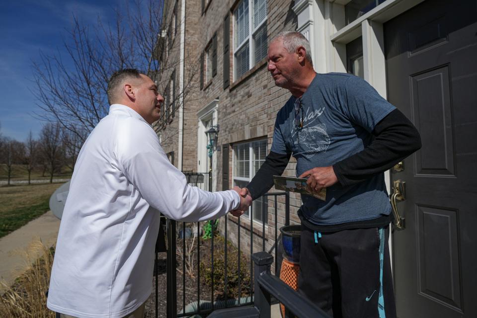 Jake Gilbert (left), a candidate for Westfield Mayor, talks with Patrick Conway on Wednesday, March 15, 2023, amid canvassing neighborhoods. Gilbert is a current city council member and head coach of the high school football team. 