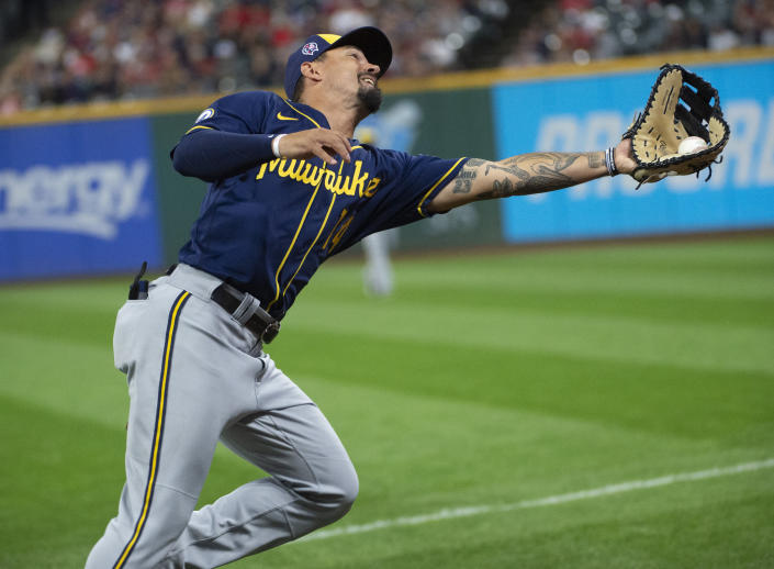 Milwaukee Brewers' Jace Peterson catches a pop foul by Cleveland Indians' Austin Hedges during the ninth inning of a baseball game in Cleveland, Saturday, Sept. 11, 2021. The Brewers won 3-0. (AP Photo/Phil Long)