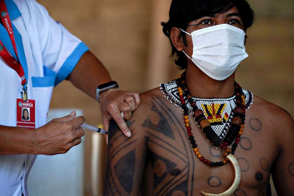 PHOTO: A Guarani indigenous man is inoculated with the Sinovac Biotech's CoronaVac COVID-19 vaccine at the Sao Mata Verde Bonita tribe camp, in Guarani indigenous land, in the city of Marica in Brazil, on Jan. 20, 2021. (Mauro Pimentel/AFP via Getty Images)