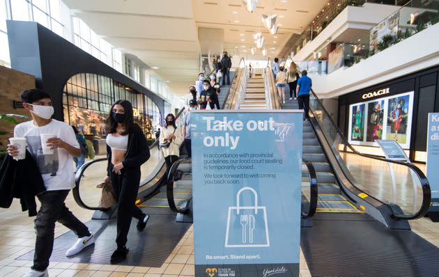 People leave after buying takeout at a food court in Yorkdale Shopping Center, Toronto, Ont., Oct. 10, 2020. CIBC says Canada's lockdowns need to be more stringent if the pandemic-stricken parts of the economy are to reopen.