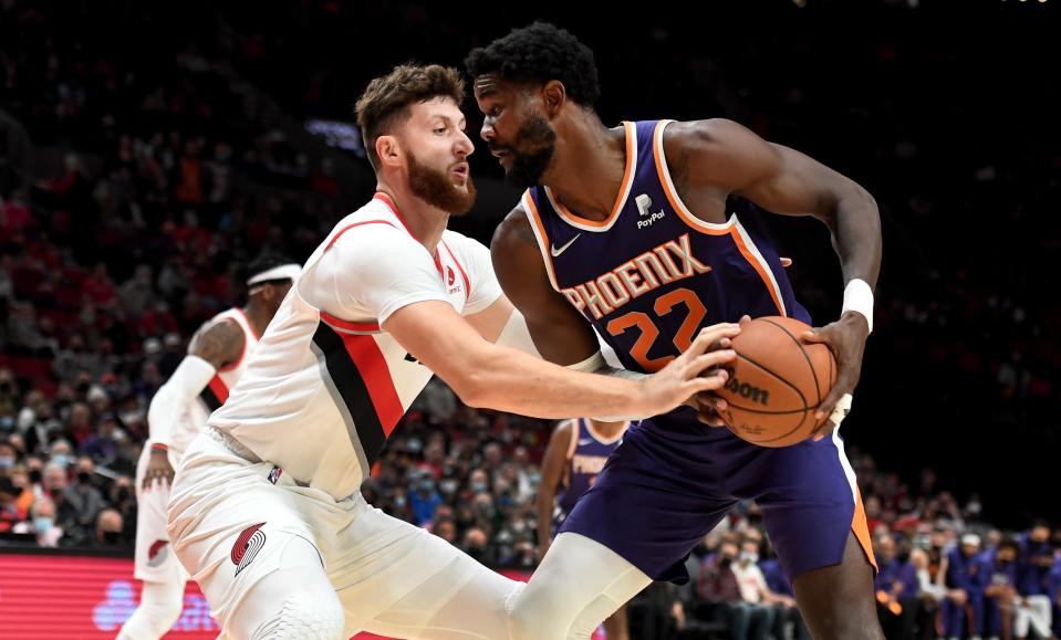Phoenix Suns center Deandre Ayton (22) looks to drive to the basket on Portland Trail Blazers center Jusuf Nurkic (27) during the first quarter of the game at Moda Center in Portland on Oct. 23, 2021.