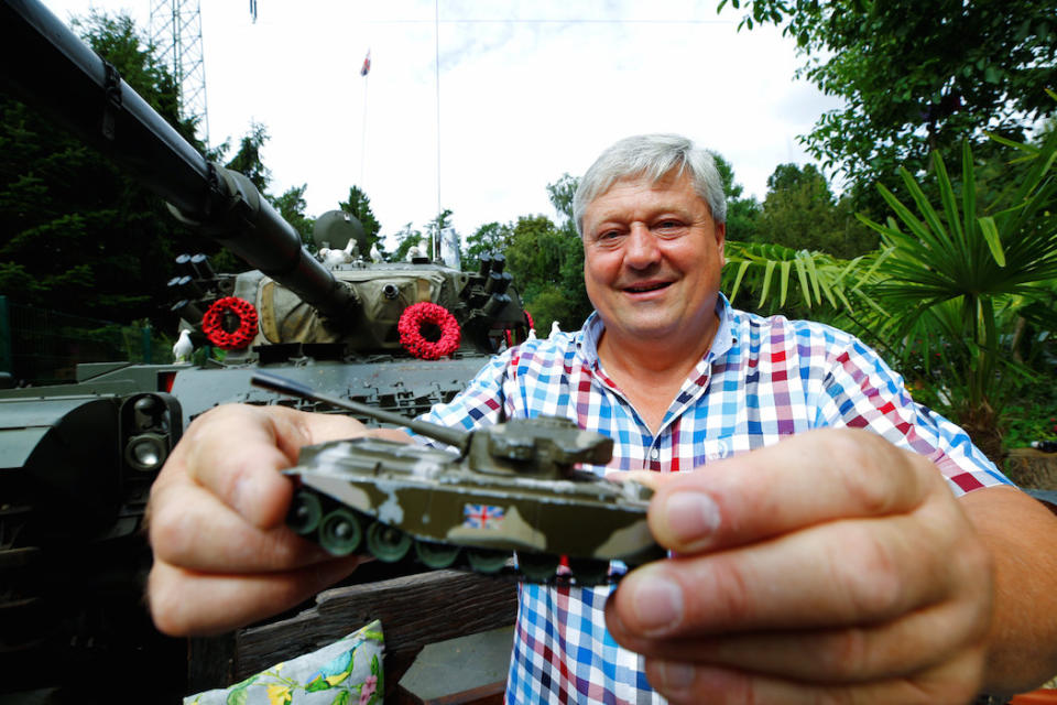 Mr Blackburn poses with a Centurion toy tank that he received from his father at the age of five (Picture: Reuters)