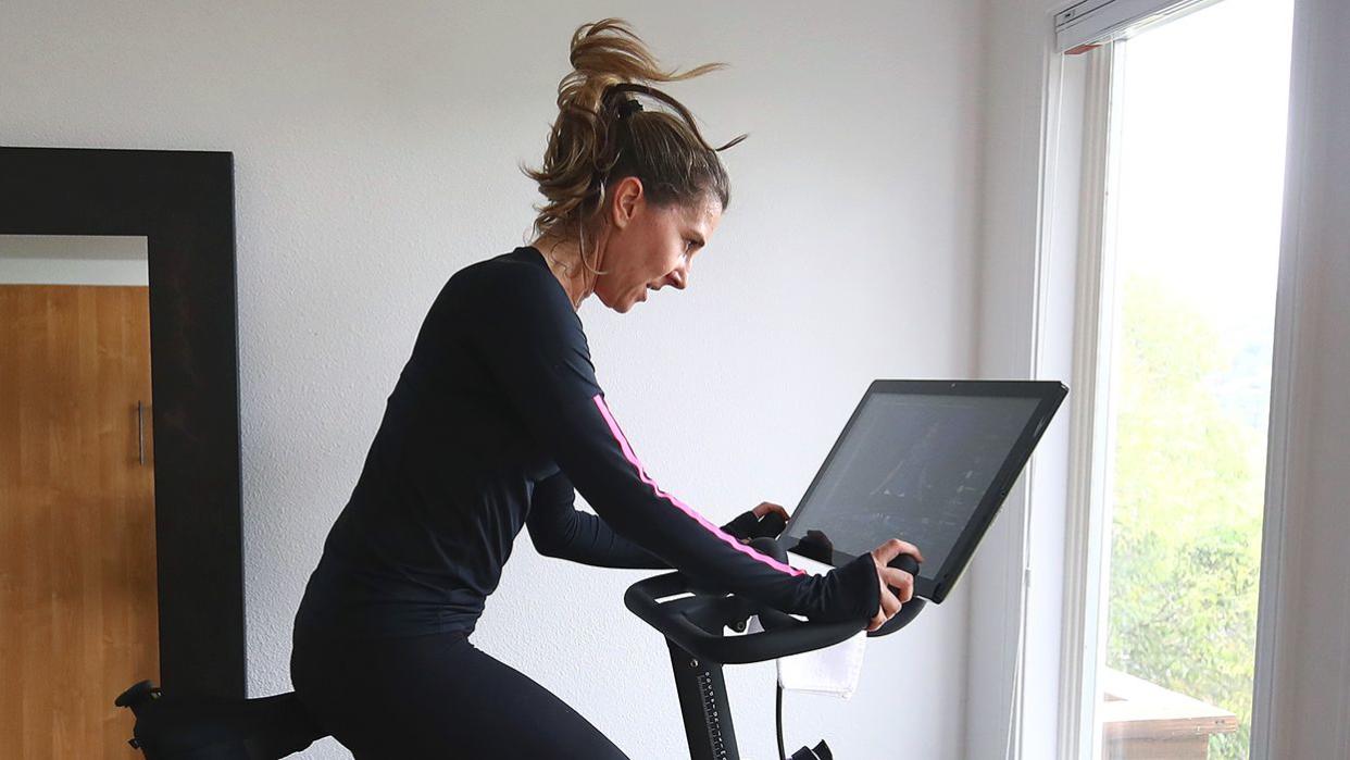 person riding a Peloton bike at home