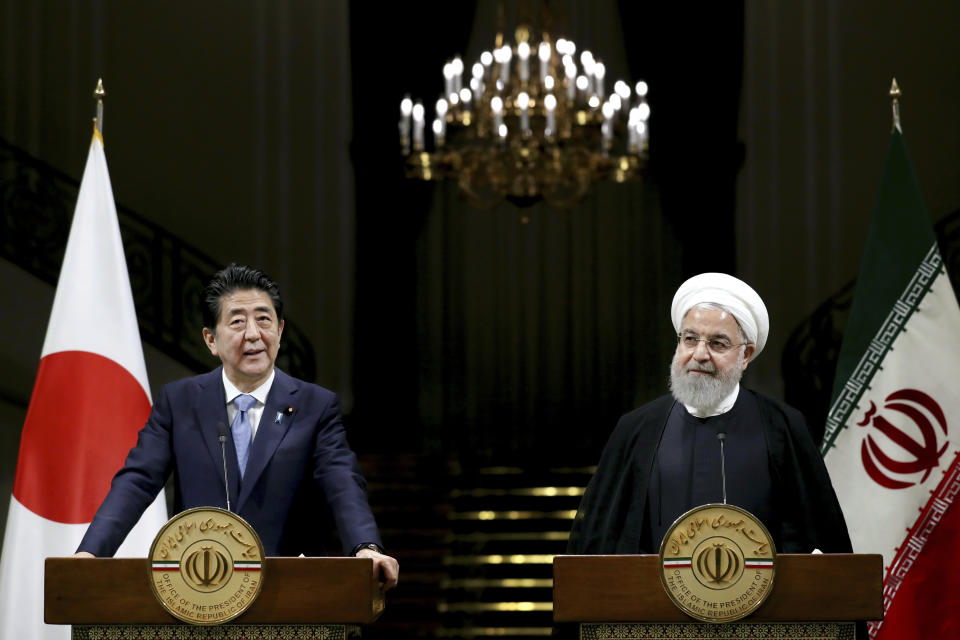 Japanese Prime Minister Shinzo Abe, left, speaks with media during a joint press conference with Iranian President Hassan Rouhani, after their meeting at the Saadabad Palace in Tehran, Iran, Wednesday, June 12, 2019. The Japanese leader is in Tehran on an mission to calm tensions between the U.S. and Iran. (AP Photo/Ebrahim Noroozi)