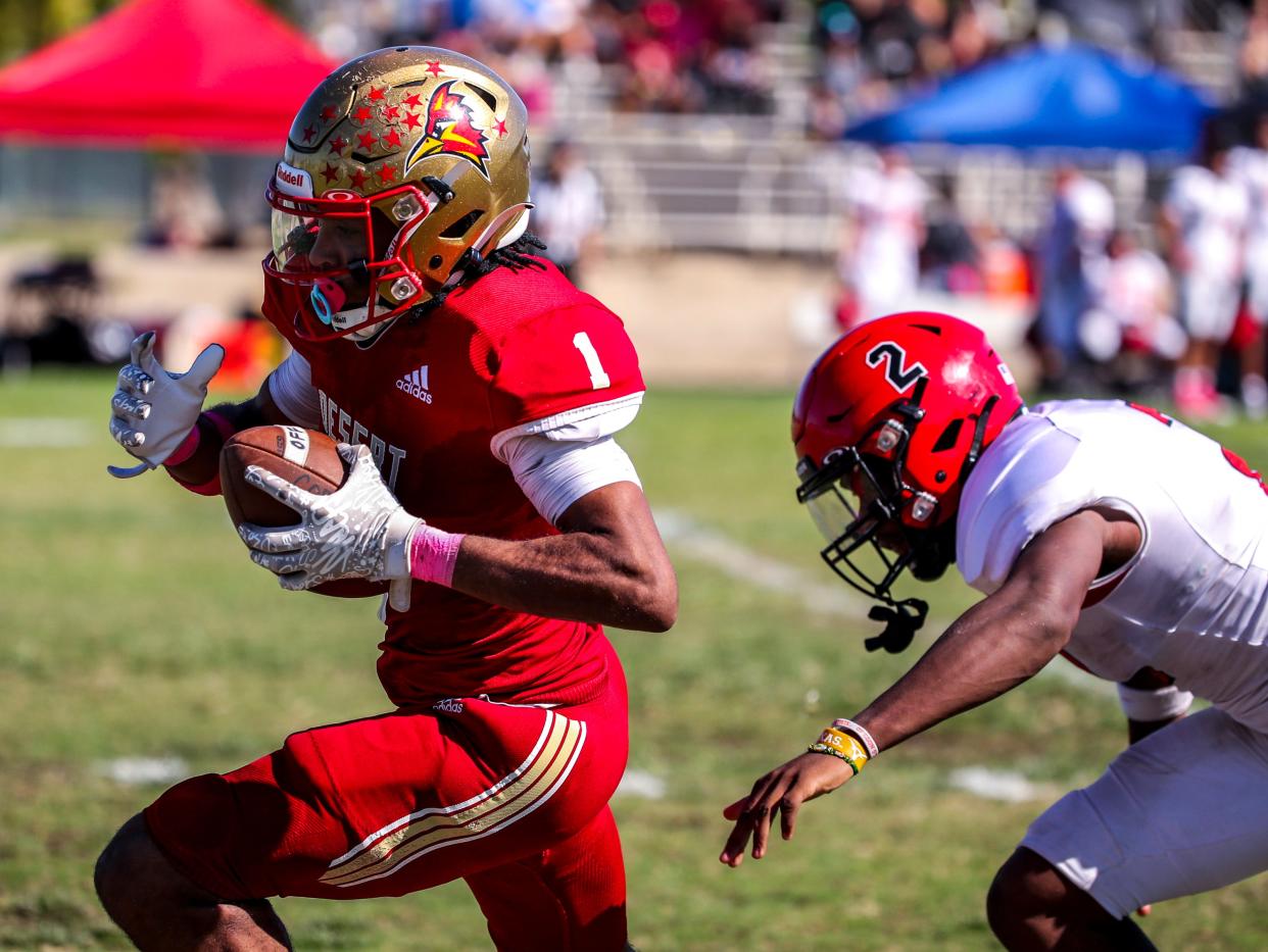 College of the Desert's Isaac Eberhardt (1) makes a catch before running in for a touchdown just out of reach of Chaffey's Asaiah Levells-Joseph (2) during the second quarter of their game at College of the Desert in Palm Desert, Calif., Saturday, Oct. 21, 2023.