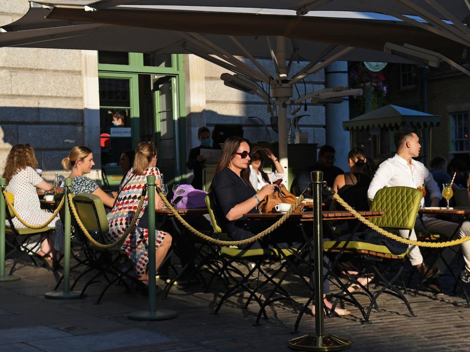 People sit outside at a restaurant in Covent Garden, London, 21 September 2020.  (Kirsty O'Connor/PA)