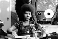 <p>Aretha Franklin is shown at a news conference sporting a printed top and stretched-out Afro. (AP Photo) </p>