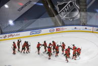 Calgary Flames players celebrate their win over the Winnipeg Jets after an NHL hockey playoff game Saturday, Aug. 1, 2020 in Edmonton, Alberta. (Jason Franson/The Canadian Press via AP)