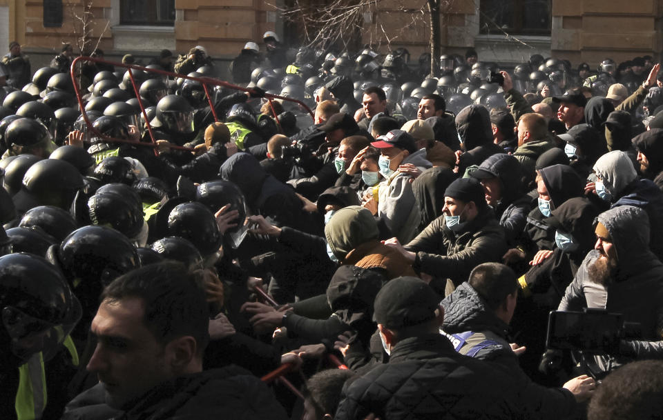 Far-right demonstrators clash with riot police outside the presidential administration building in Kiev, Ukraine, Saturday, March 9, 2012. Three police officers in Ukraine have been injured in a clash with far-right demonstrators in the capital. The violence occurred outside the presidential administration building in Kiev where several hundred demonstrators had gathered Saturday to call for arrests of top figures in an alleged military corruption scandal. (AP Photo/Vladimir Donsov)