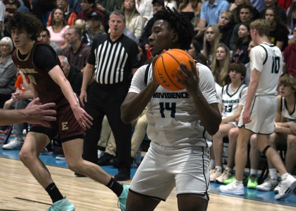 Providence forward Abdul Mansaray (14) pulls down a rebound against Episcopal.