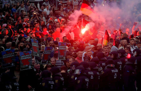 FILE PHOTO: Right-wingers protest in Chemnitz, Germany, August 27, after a German man was stabbed. REUTERS/Matthias Rietschel/File Photo