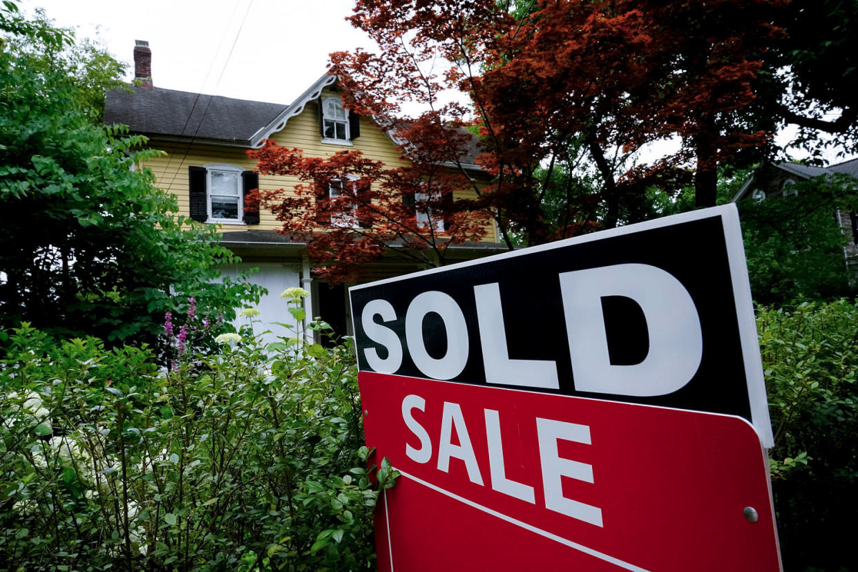 A sale sign stands outside a home (Matt Rourke / AP file)