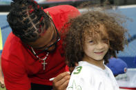 CAPTION CORRECTION: CORRECTS NAME SPELLING: Buffalo Bills defensive back Damar Hamlin signs a autograph for a young fan following the announcement of the first program of his Chasing M's Foundation, the Chasing M's Foundation CPR Tour, Saturday, June 3, 2023, in Orchard Park, N.Y. (AP Photo/Jeffrey T. Barnes)