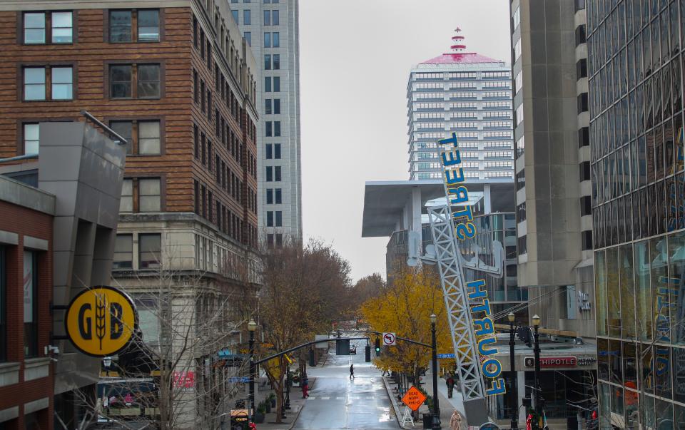 A few pedestrians along Fourth Street on a December afternoon recently. Downtown Louisville has experienced fewer people since 2020, according to a study of cell phone traffic. Dec. 5, 2023