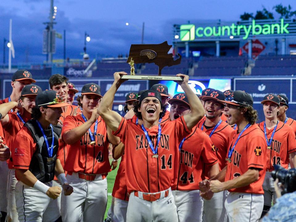 Taunton's Johnny Escobalez (center) hoists up the 2023 MIAA Division I Baseball State Championship trophy in celebration after beating Franklin 7-2 to secure the program's second-straight title.