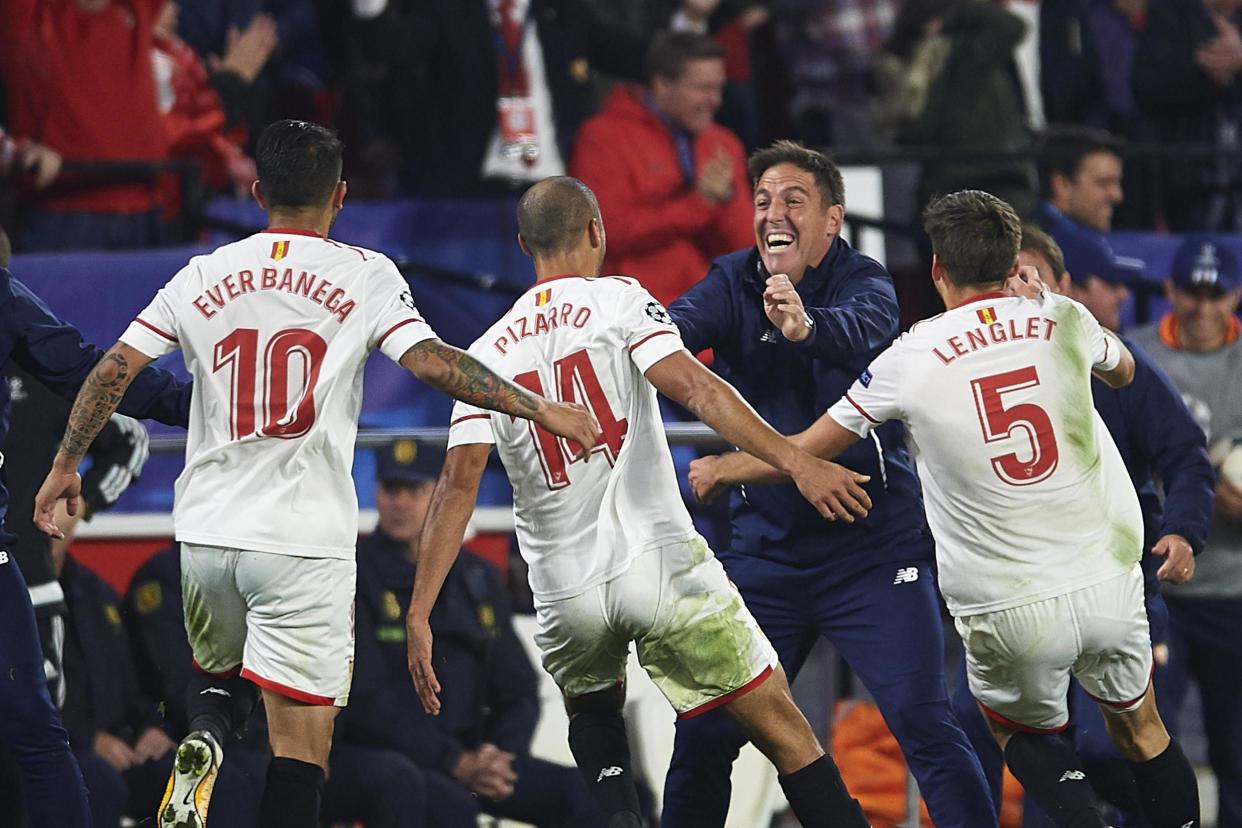 Sevilla players celebrate their late equaliser with head coach Berizzo: Getty Images