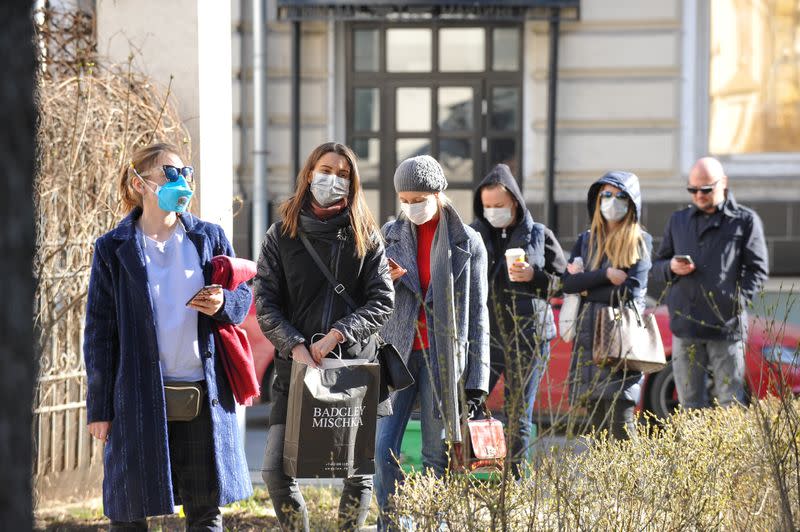 People queue before undergoing medical tests for coronavirus disease at a laboratory in Moscow