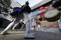 Dancers in traditional costumes perform to celebrate after the opening ceremony of the 2019 trading year at the Korea Exchange in Seoul, South Korea, Wednesday, Jan. 2, 2019. (AP Photo/Lee Jin-man)