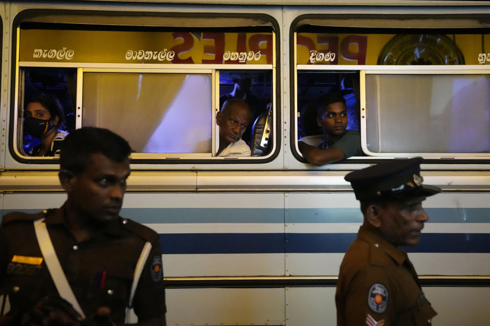 Commuters look on as police officers search a passenger bus during a search operation against narcotics in Colombo, Sri Lanka, Thursday, Jan. 18, 2024. (AP Photo/Eranga Jayawardena)