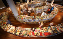 LONDON, ENGLAND - JULY 31: Visitors enjoy the 'aMAZEme' labyrinth made from books at The Southbank Centre on July 31, 2012 in London, England. Brazilian artists Marcos Saboya and Gualter Pupo used 250,000 books to create the maze which will be on display until August 25, 2012. (Photo by Peter Macdiarmid/Getty Images)