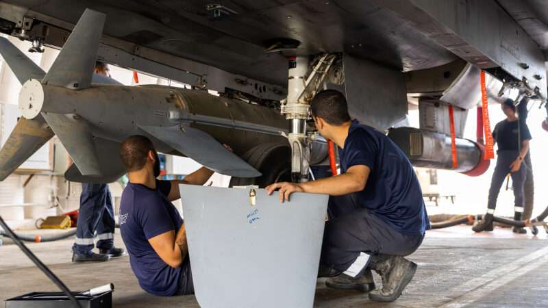 Israeli technicians arm an F-15 fighter jet with JDAM ordnance at Ramon Air Base in Israel on October 16, 2023.