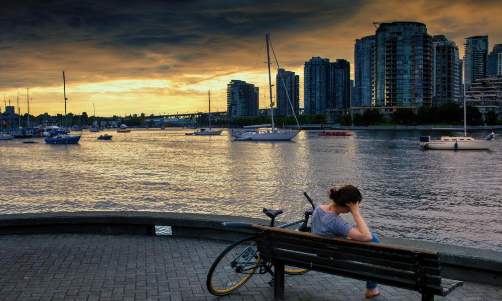 A woman on a bench by a dock