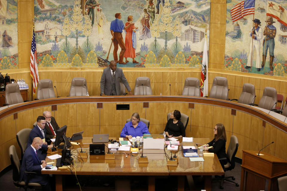 Senate President, state Senator Steven Bradford, D-Gardena, standing center, begins the session in one of the Senate committee rooms after a woman threw red liquid from the public gallery in the Senate chambers, in Sacramento, Calif., Friday, Sept. 13, 2019. The woman was taken into custody and with authorities investigating the substance thrown, Senate leadership decided to finish their work in the committee room. Friday is the last day of this year's legislative session. (AP Photo/Rich Pedroncelli)