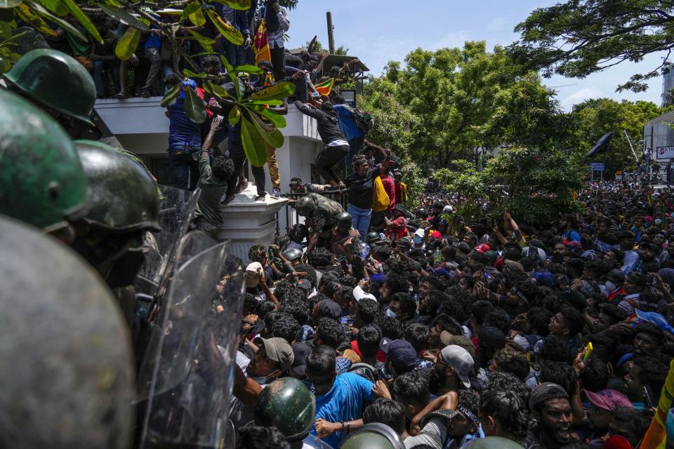 Protesters storm Sri Lankan Prime Minister Ranil Wickremesinghe's office, demanding he resign after president Gotabaya Rajapaksa fled the country amid economic crisis in Colombo, Sri Lanka, July 13, 2022. The image was part of a series of images by Associated Press photographers that was a finalist for the 2023 Pulitzer Prize for Breaking News Photography. (AP Photo/Rafiq Maqbool)