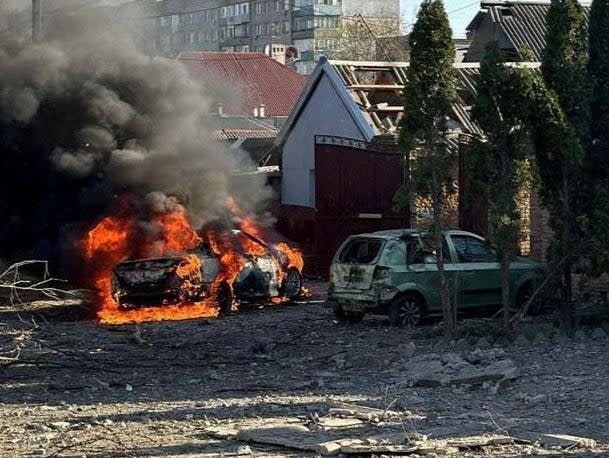 A car burns at the site of a Russian missile strike in Zaporizhzhia (via REUTERS)