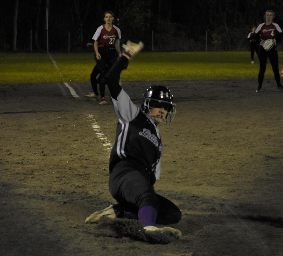 Little Falls Muntie Olivia Brand slides home with a run on a wild pitch against Vernon-Verona-Sherrill Thursday during the first game of the season under the Veterans Memorial Park lights in Little Falls.