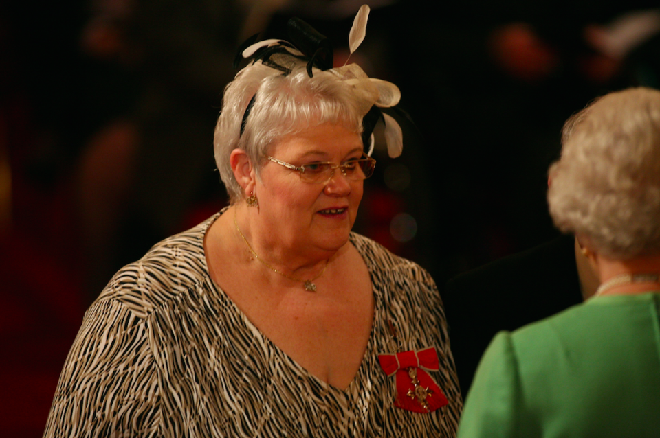 Foster carer Penelope Jones receives her MBE from the Queen in 2010 (Picture: PA)