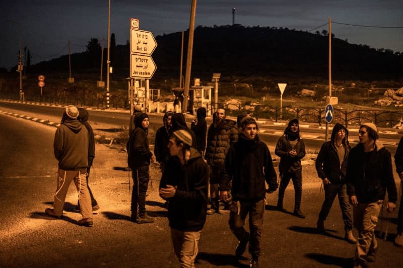 Israeli settlers try to block the road at the site of a shooting attack in Huwara area. The European Union is imposing sanctions on radical Israeli settlers in the West Bank for the first time over acts of violence against Palestinians, diplomats confirm to dpa. Ilia Yefimovich/dpa