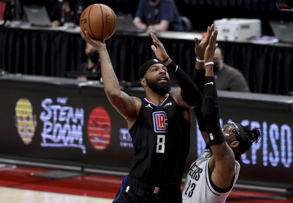 Clippers forward Marcus Morris Sr. goes up for a shot over Portland Trail Blazers forward Robert Covington.