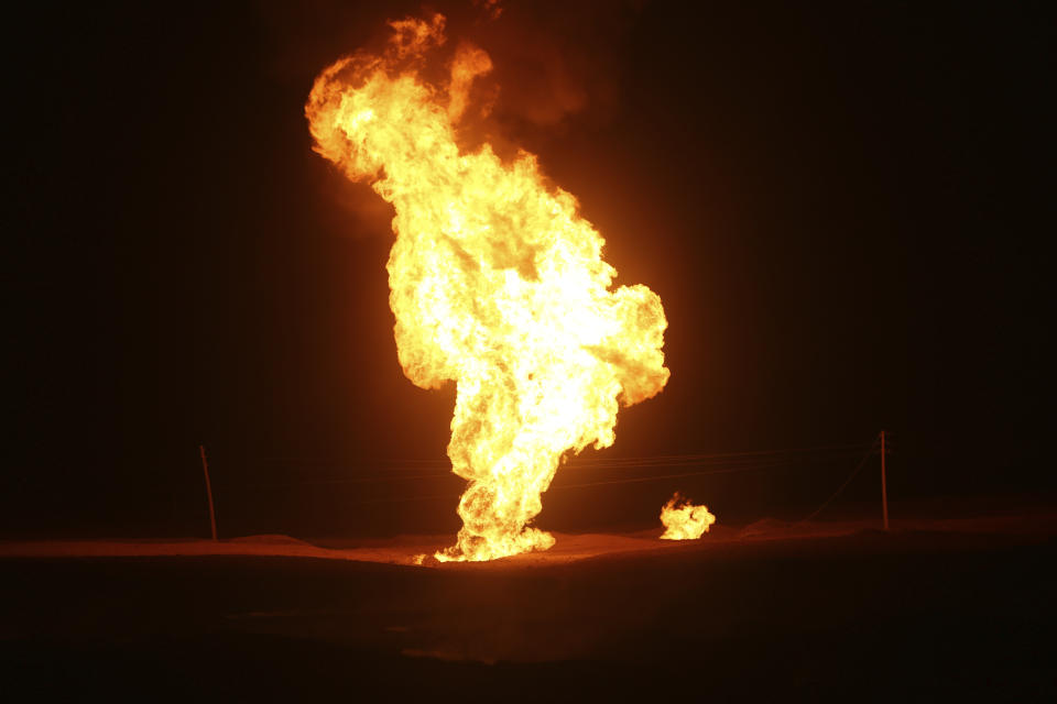 Flames leap into the air after a natural gas pipeline explodes outside the city of Boroujen in the western Chaharmahal and Bakhtiari province, Iran, in early Wednesday, Feb. 14, 2024. Explosions struck a natural gas pipeline in Iran early Wednesday, with an official blaming the blasts on a "sabotage and terrorist action" in the country as tensions remain high in the Middle East amid Israel's war on Hamas in the Gaza Strip. (Reza Kamali Dehkordi/Fars News Agency via AP)