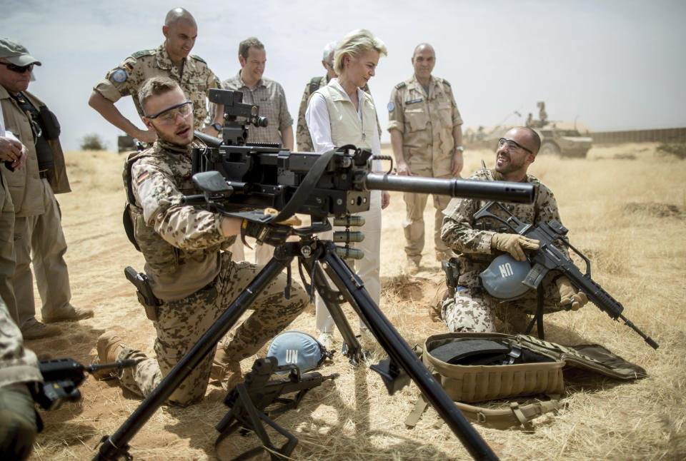 FILE - German defense minister Ursula von der Leyen, center, speaks with German soldiers stationed as part of the Mission ASIFU-MINUSMA at Camp Castor near Gao, Mali, April 5, 2016. The pending pullout of U.N. peacekeepers from Mali is creating worries about what the withdrawal will mean for thousands of citizens who built livelihoods at and around the mission's bases. (Michael Kappeler/Pool Photo via AP-file)
